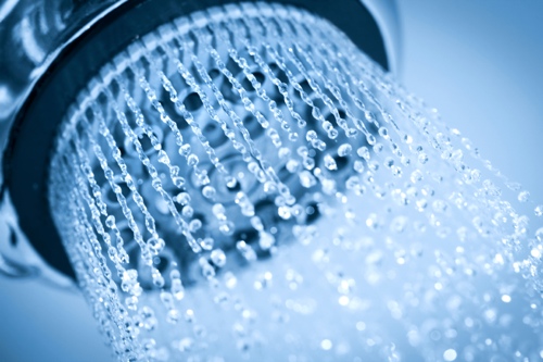 Showerhead with running water with a blue hue